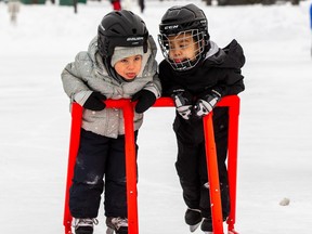 Leo Gillespi,3, (left) and his friend Cairo Garcia,3, (right) take advantage of the warmer weather as they learn to skate together on the lake at Hawrelak Park on Sunday, Jan. 2, 2022 in Edmonton. Greg Southam-Postmedia