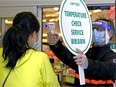 A T&T Supermarket employee points a temperature gun at a customer at the entrance to the south Edmonton store on April 23, 2020. File photo.