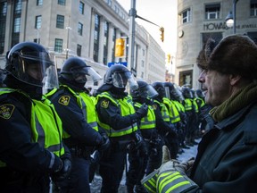 Police in Ottawa slowly push back protesters who have occupied the city core for three weeks.