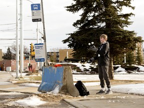 Brady Gamble, 14, juggles snowballs as he waits at a transit stop in Edmonton on Thursday Feb. 17, 2022.