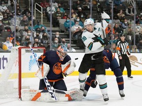 Edmonton Oilers goaltender Stuart Skinner (74) makes a save as San Jose Sharks center Logan Couture (39) screens during the second period at SAP Center at San Jose on Feb. 14, 2022.