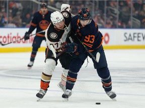Edmonton Oilers' Ryan Nugent-Hopkins (93) battles Anaheim Ducks' Rikard Rakell (67) during first period NHL action at Rogers Place in Edmonton, on Thursday, Feb. 17, 2022.