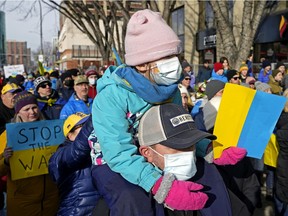 Anna Drobina, 5, and her father Wojciech joined hundreds who  rallied in support of Ukraine in downtown Edmonton on Sunday, Feb. 27, 2022. Russia has invaded Ukraine and the Russian army is conducting military operations against the Ukrainian people, targeting several cities, including an attempt  to take over Ukraine's capital, Kyiv.