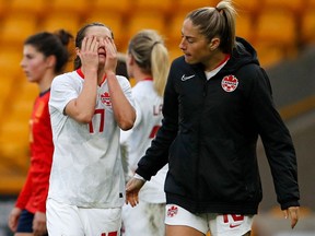 Canada's midfielder Jessie Fleming (left) reacts with Janine Beckie after the Arnold Clark Cup women's international football match between Spain and Canada at the Molineux stadium in Wolverhampton, central England on February 23, 2022. Spain won the match 1-0.