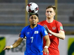 El Salvador's midfielder Jairo Henriquez (L) and Canada's defender Scott Kennedy eye the ball during the FIFA World Cup Concacaf qualifier football match between El Salvador and Canada at Cuscatlan Stadium in San Salvador on February 2, 2022.