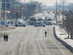 A line of trucks waits for the road to the Ambassador Bridge to reopen after the cross-border bridge was blocked Monday night by anti-mandate protesters.