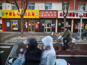 Beijing residents commute on a Monday morning as seen from a closed loop bus during the Beijing 2022 Winter Olympics on Monday, February 14, 2022.