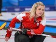 Team Canada skip Jennifer Jones intently watches her shot during a game against the United States at the Beijing 2022 Winter Olympics.