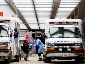 An ambulance crew member delivers a patient at Toronto's Mount Sinai Hospital on Jan. 3, 2022.