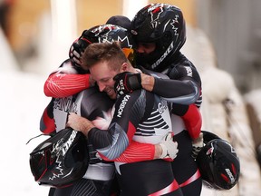 Justin Kripps, Ryan Sommer, Cam Stones and Benjamin Coakwell of Team Canada react to their slide during the four-man Bobsleigh heat 4 on day 16 of Beijing 2022 Winter Olympic Games.