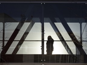 The afternoon sun silhouettes pedestrians as they walk through the pedway at the Royal Alexandra Hospital on Tuesday, Feb. 1, 2022 in Edmonton.