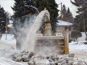 A giant snowblower cleans up pieces of ice and snow that  missed the truck used to carry away the windrow from a street in the east end of the city on Feb. 23, 2022.