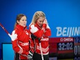 Team Canada’s Kaitlyn Lawes and Jennifer Jones talk during their game against Russia at the Beijing 2022 Winter Olympics.