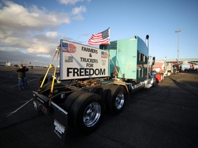 Truckers and their supporters start to gather before a convoy leaves the following morning bound for the nation's capital to protest against COVID-19 vaccine mandates, in Adelanto, Calif., Tuesday, Feb. 22, 2022.