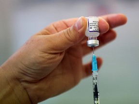 A health worker prepares a dose of the COVID-19 booster vaccine at Midland House in Derby, Britain, September 20, 2021