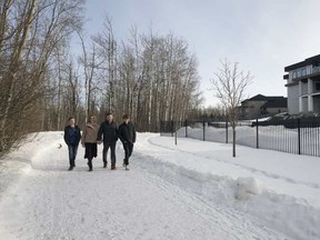 The Webber family — from left, Benjamin, 14, Christine, Cregg and Matthew, 16 — take a walk in their new community of WestPointe of Windermere.