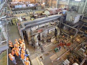 A tour group watches the reconstruction of the power island at Unit 3 at the Boundary Power Station where the world's first commercial-scale, clean-coal power project is housed in Estevan, SK.
