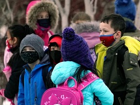 School children outside a school in southwest Edmonton on Monday February 14, 2022, the first day that the mask mandate in the province of Alberta was lifted. School children are no longer  required to wear face masks at any school in the province.