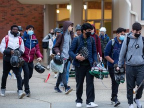 Most students leaving Austin O'Brien High School to get on a bus wear masks on Monday, Feb. 14, 2022 even thought the provincial mandate to wear a mask in schools has been stopped.