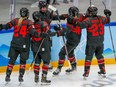 Team Canada’s Sarah Fillier is congratulated by teammates after scoring against Switzerland at the 2022 Winter Olympics.