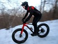 A mountain biker rides along a trail in Edmonton's river valley on Thursday Feb. 3, 2022. The mountain biking community is opposing a proposed policy that could restrict cycling in many areas of the river valley.