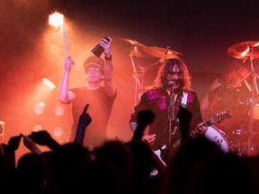 Lead singer and lead guitarist Justin Hawkins, right, of The Darkness performs on stage at Union Hall in Edmonton, on Wednesday, March 23.