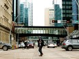 A pedestrian makes their way through downtown Edmonton, on Tuesday March 1, 2022.