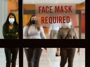 Office workers make their way through a city centre pedway in downtown Edmonton, on Tuesday March 1, 2022. An Edmonton Downtown Business Association survey indicates that about 70% of workers are expected to return to work downtown by summer.