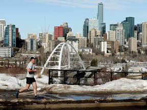 A jogger wearing shorts and a short sleeve shirt makes their way along Saskatchewan Drive in Edmonton, on Thursday March 17, 2022.