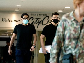 Pedestrians make their way across a pedestrian walkway between City Centre Mall and Manulife Place, in downtown Edmonton, Friday March 25, 2022.