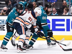 Edmonton Oilers centre Ryan Nugent-Hopkins (93) competes for the puck against San Jose Sharks Logan Couture (39) and Brent Burns (88) at SAP Center in San Jose, Calif., on Nov 19, 2019.