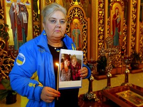 Ukrainian/Canadian, Christine Moussienko who's sister Svitlana Moussienko is trapped in Chernihiv under heavy shelling and surrounded by the Russians prays at the Ukrainian church in Calgary on Wednesday, March 2, 2022. Darren Makowichuk/Postmedia