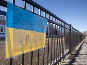 Signs of support for Ukraine in the war with Russia are posted on the fence in front of St. Brendan School on Friday, March 18, 2022, in Edmonton.