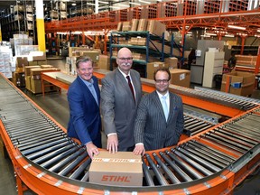At Stihl's packeage sorting area, from left, is Clark Grue, CEP Rainmaker Global Market Access, Malcolm Bruce, CEO Edmonton Global and Myron Keehn, Edmonton International Airport, VP Air Services and Business Development as Port Alberta held a relaunched to further develop and promote the Edmonton Metropolitan Region as an inland port, focusing on attracting foreign investment and helping regional businesses trade with the world, at Stihl distribution centre in Acheson west of Edmonton, March 23, 2022. Ed Kaiser/Postmedia