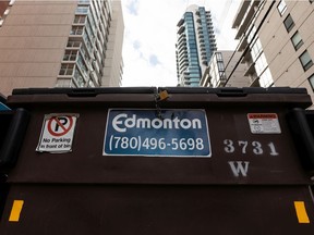 An Edmonton waste container is seen behind a multi-unit building in the Oliver neighbourhood of Edmonton, on Friday, March 25, 2022.  The City of Edmonton's Utility Committee has voted to recommend three-streaming public waste collection which now heads to city council for approval. Photo by Ian Kucerak