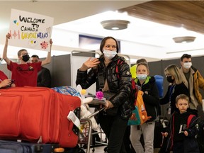 Displaced people arrive on a Polish Airlines flight from Warsaw at Edmonton International Airport, on Monday, March 28, 2022.