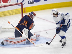 Edmonton Oilers goalie Mikko Koskinen (19) makes a save on Tampa Bay Lightning Brayden Point (21) on Saturday, March 12, 2022, in Edmonton.