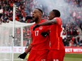 Canada's Cyle Larin (17) celebrates scoring a goal with Richie Laryea (22) in a FIFA World Cup qualifying game against Jamaica at BMO Field in Toronto, Ont., on March 27, 2022.