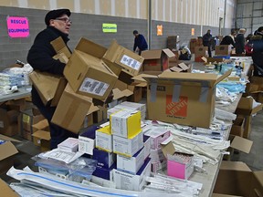 Volunteers packing boxes of emergency response supplies trying to fill a plane, that will be airlifted to the Ukraine, at a warehouse in west in Edmonton, March 4, 2022. The Ukrainian Canadian Congress Alberta Provincial Council has joined forces with Firefighter Aid to Ukraine with this response.