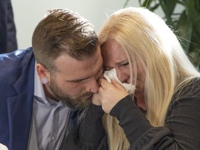Cody Bonkowsky consoles Kelly Schneider as they speak with media about their class action law suit against the Calgary Board of Education and the estate of Michael Gregory, who was a teacher at John Ware Junior High School in Calgary. The claim alleges that, from approximately 1989 to 2006, Mr. Gregory sexually assaulted and interfered with approximately 200 teenage girls aged 14 to 16. The press conference took place on Monday, November 29, 2021. 

Gavin Young/Postmedia