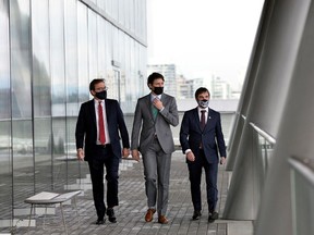 Prime Minister Justin Trudeau, Environment and Climate Change Minister Steven Guilbeault and Natural Resources Minister Jonathan Wilkinson walk during the Globe Forum 2022 at the Vancouver Convention Centre, British Columbia, Canada March 29, 2022.