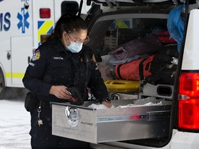 Incident Response Paramedic Tracy Griffin checks supplies in her paramedic response unit, as she poses for a photo in Edmonton on Monday, Jan. 24, 2022.