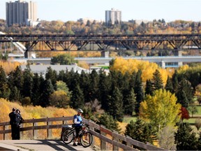 A cyclist stops to look at the fall colours in Edmonton's river valley, on Oct. 1, 2021.