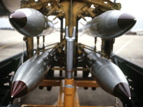 A frontal view of four B-61 nuclear free-fall bombs on a bomb cart.