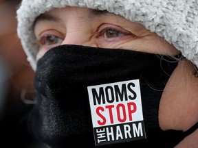 Angela Welz, board member with Moms Stop The Harm, takes part in a protest organized by Albertans For Ethical Drug Policy at the Alberta legislature in Edmonton on Feb. 23, 2022.