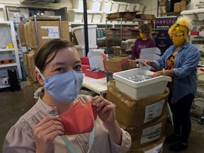 UnBelt employees Krista Kohuch (front), Tanis Zac (right) and Sabrina Sponagle helped distribute 20,000 face masks to Edmonton schools shortly after the global pandemic was declared.