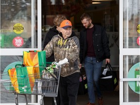 John and Morna Wowk load groceries into their SUV at Sobey's Belmont location at 13504 Victoria Trail in Edmonton, on Tuesday, March 17, 2020.