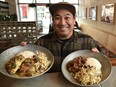 Ariel Del Rosario, co-owner of Filistix restaurant, holding two dishes South Pacific coconut chicken and pork adobo on the menu for Filipino Restaurant Month.
