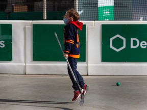 Joseph Forward, 8, shoots some ball hockey during the opening day of Rogers Hometown Hockey at ICE District in Edmonton, on Friday, April 1, 2022. The event is on through April 4.