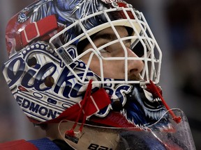 Edmonton Oil Kings goaltender Sebastian Cossa (33) looks at the scoreboard against the Lethbridge Hurricanes at Rogers Place in Edmonton on Saturday, April 23, 2022.